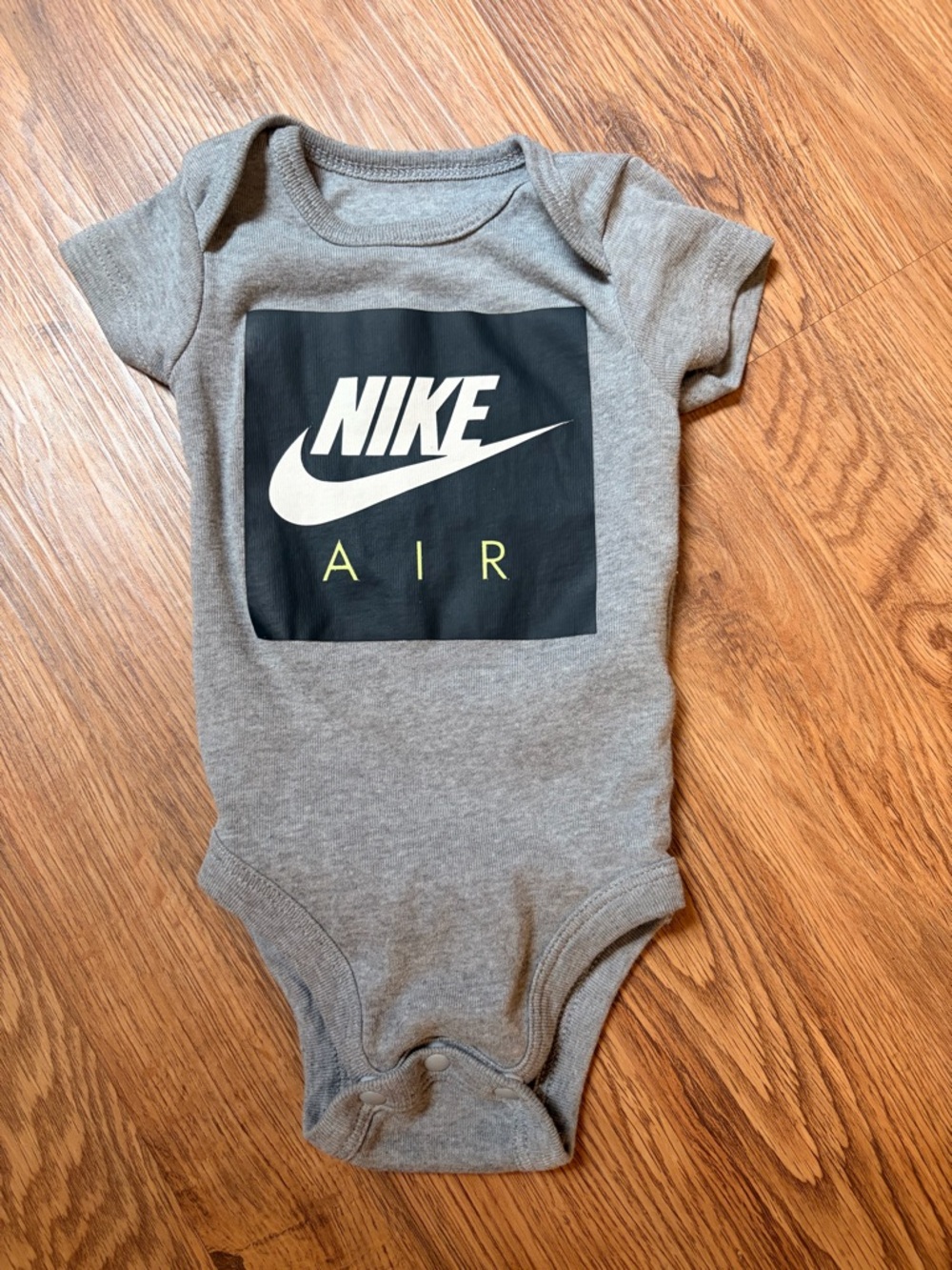 Nike Gray Baby Bodysuit with Black Swoosh